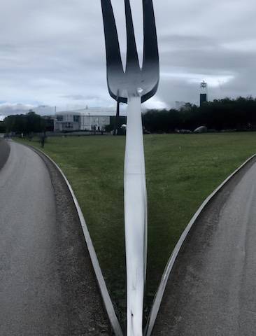 A left road and a right road separated by
       a giant stainless steel fork -- Made in Dall-E